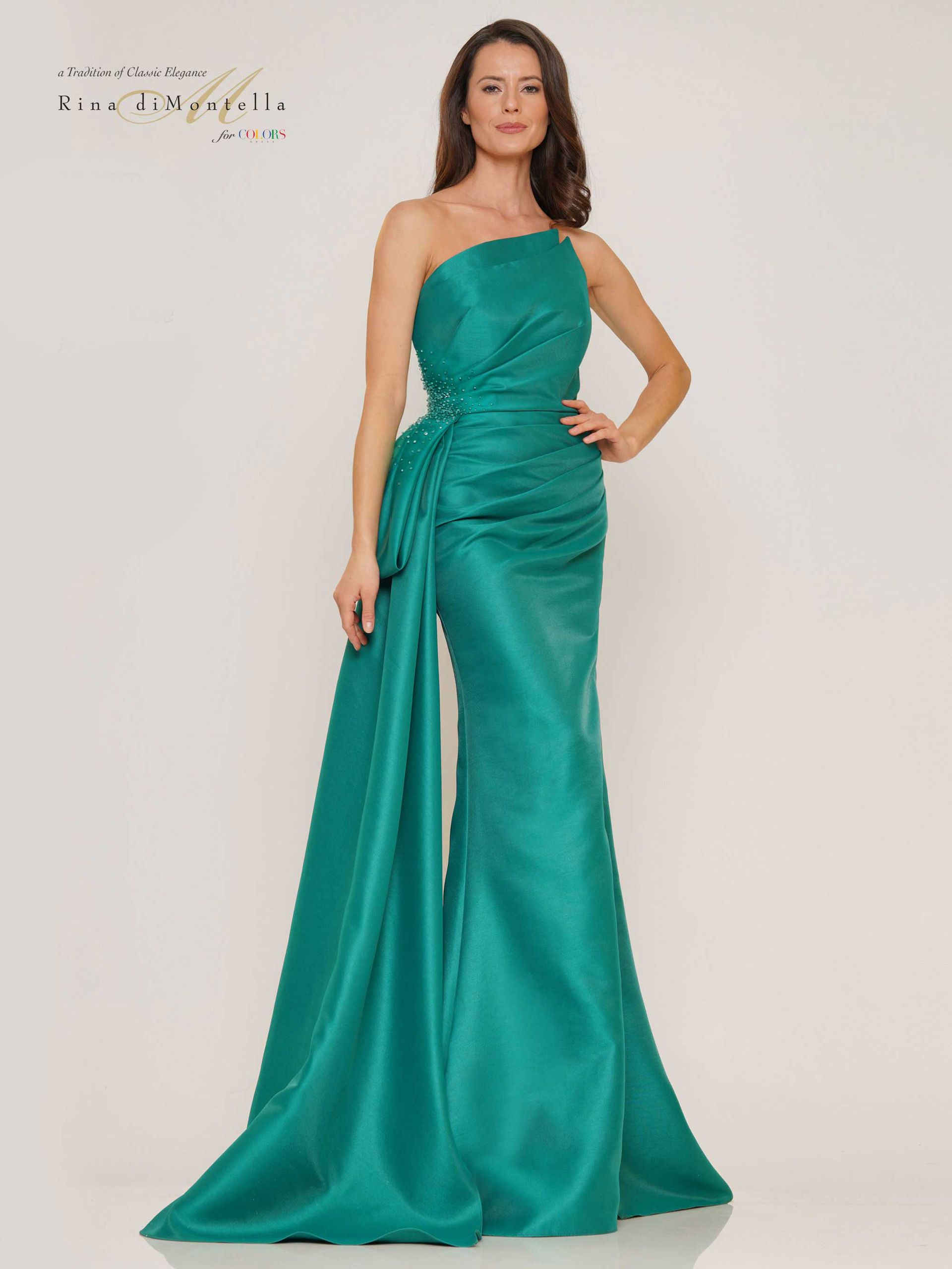 A woman is wearing a green one shoulder dress