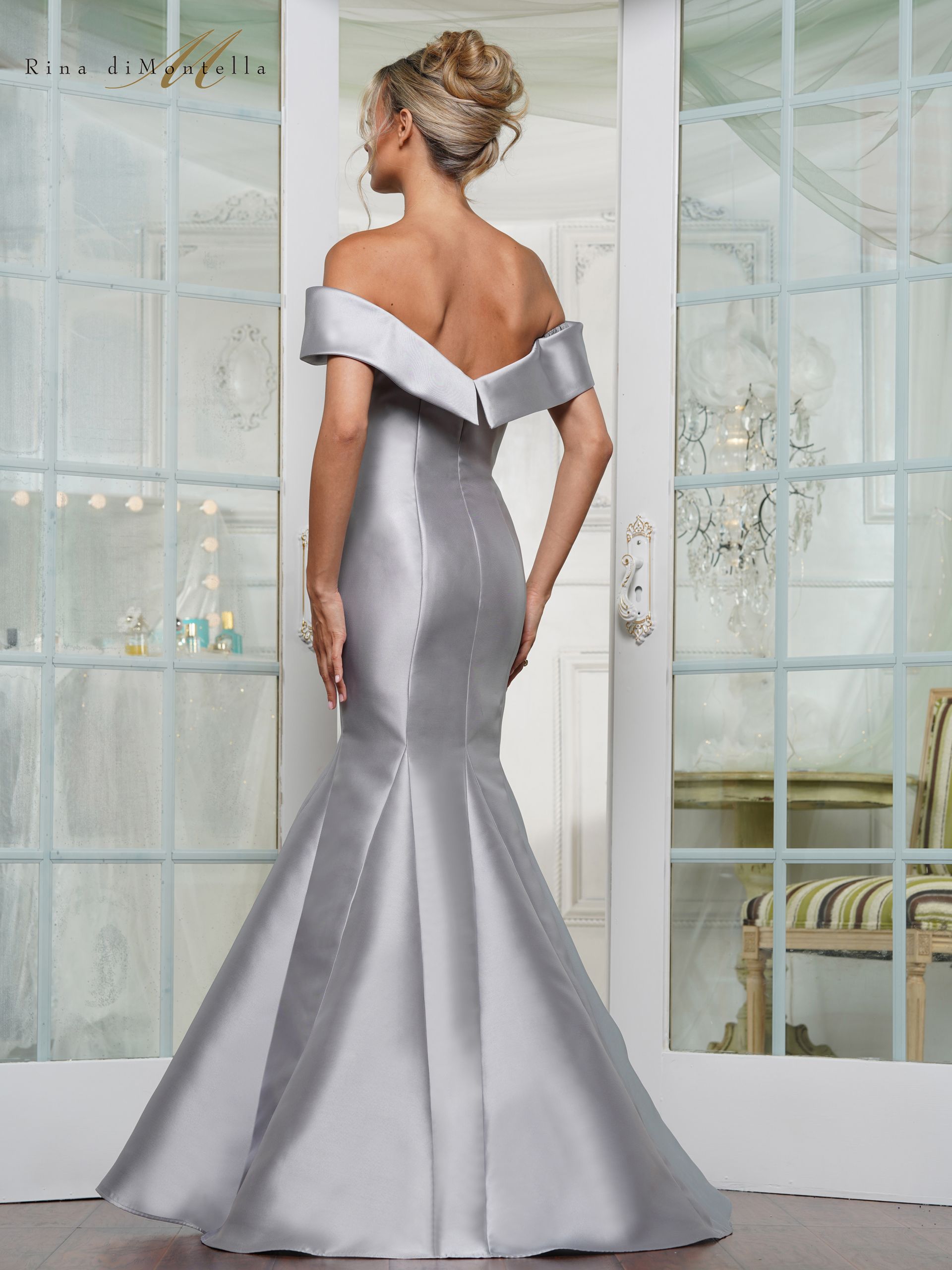 The back of a woman wearing a silver off the shoulder dress