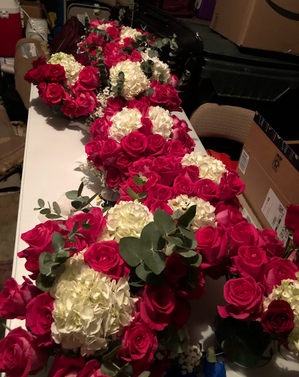 A row of pink and white flowers on a table