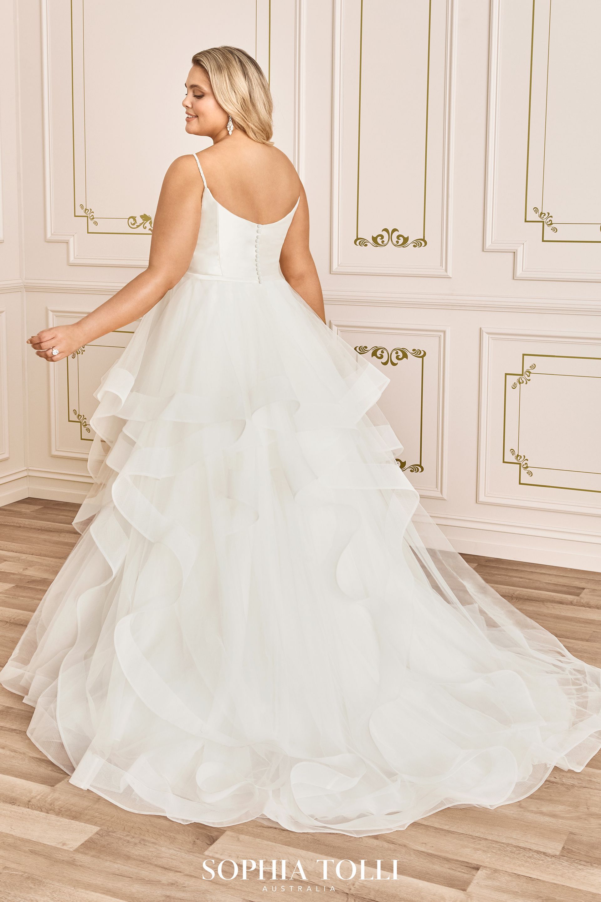 The back of a plus size wedding dress by sophia tolli is shown.