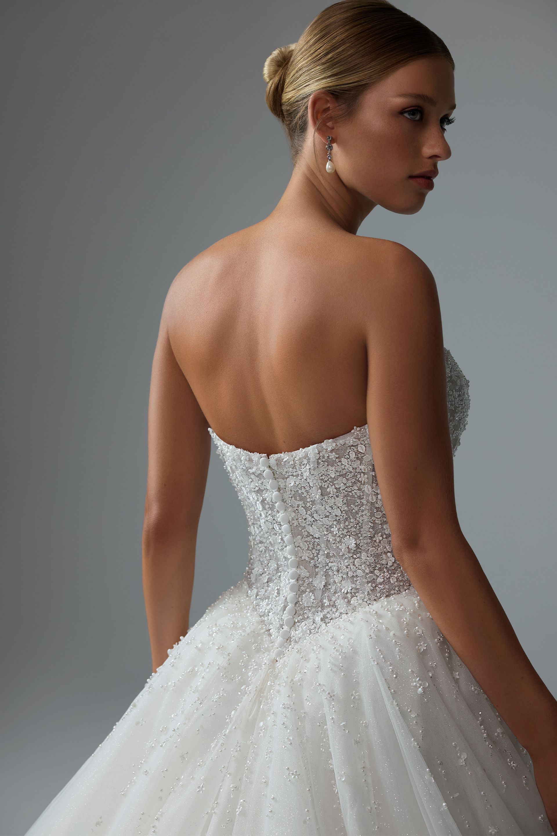 The back of a woman wearing a white wedding dress