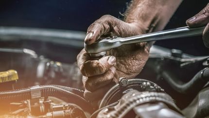 A Mechanic Using a Wrench to Work on A Car Engine — Dunn's Auto Repair in Bundaberg East, QLD