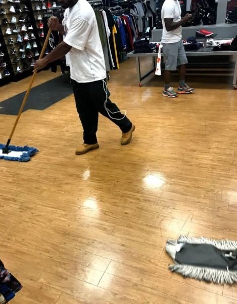 Man mopping a store floor.