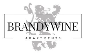 Brandywine Apartments logo with "BRANDYWINE" in a dark font over "APARTMENTS" in a light blue font.