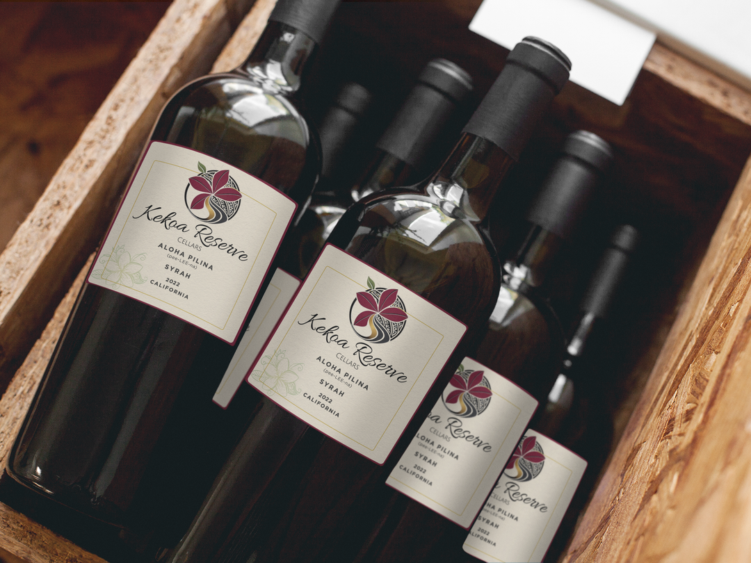 Wine bottles in wooden crate, labels with red flower graphic.