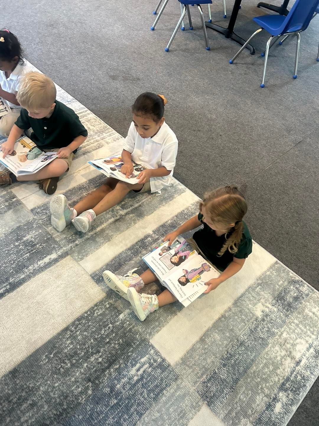 A group of children are sitting around a table with balloons.