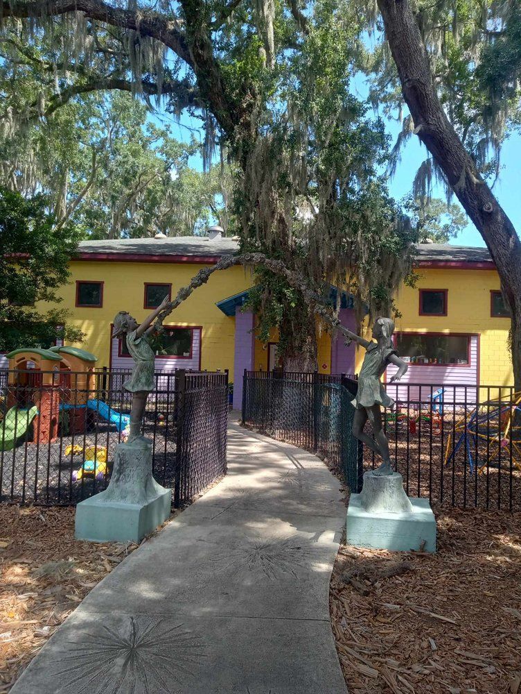 A group of children are sitting at tables in a classroom.