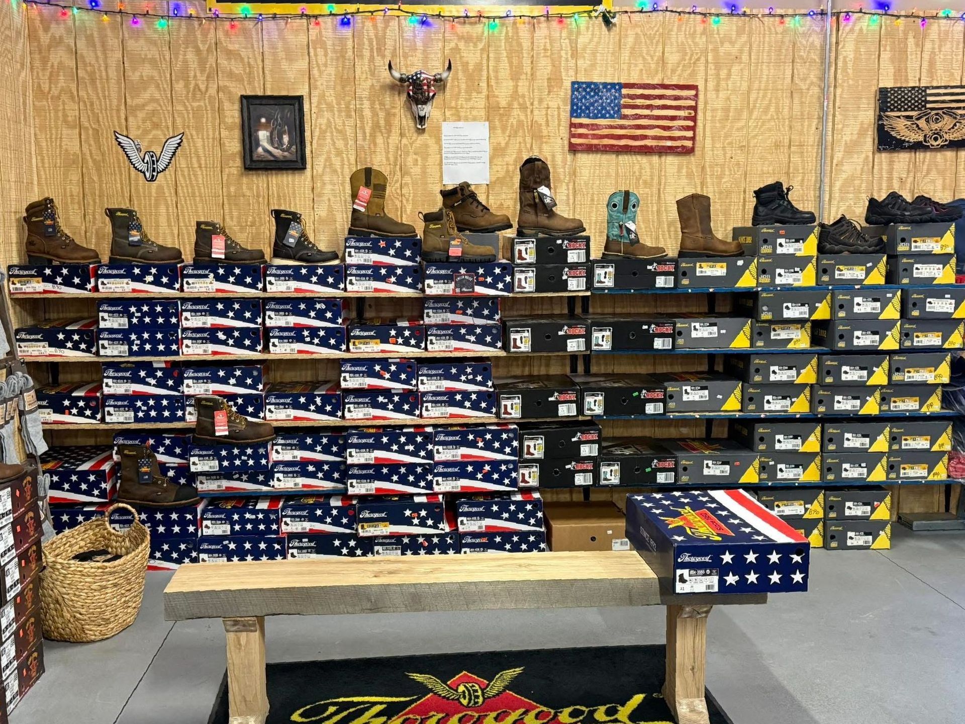 A row of cowboy boots are lined up on a shelf in a store.