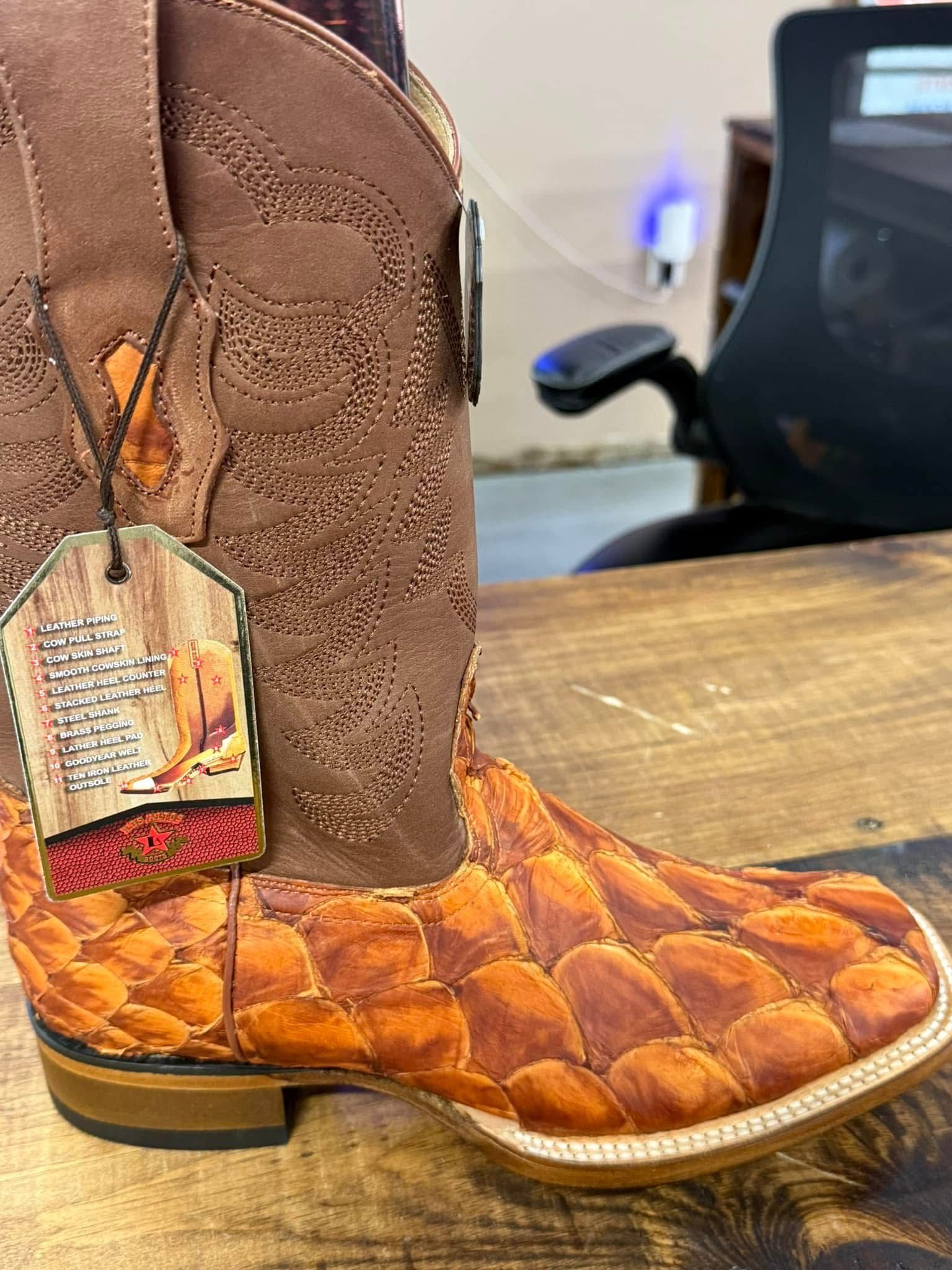 A person wearing a pair of american flag cowboy boots.
