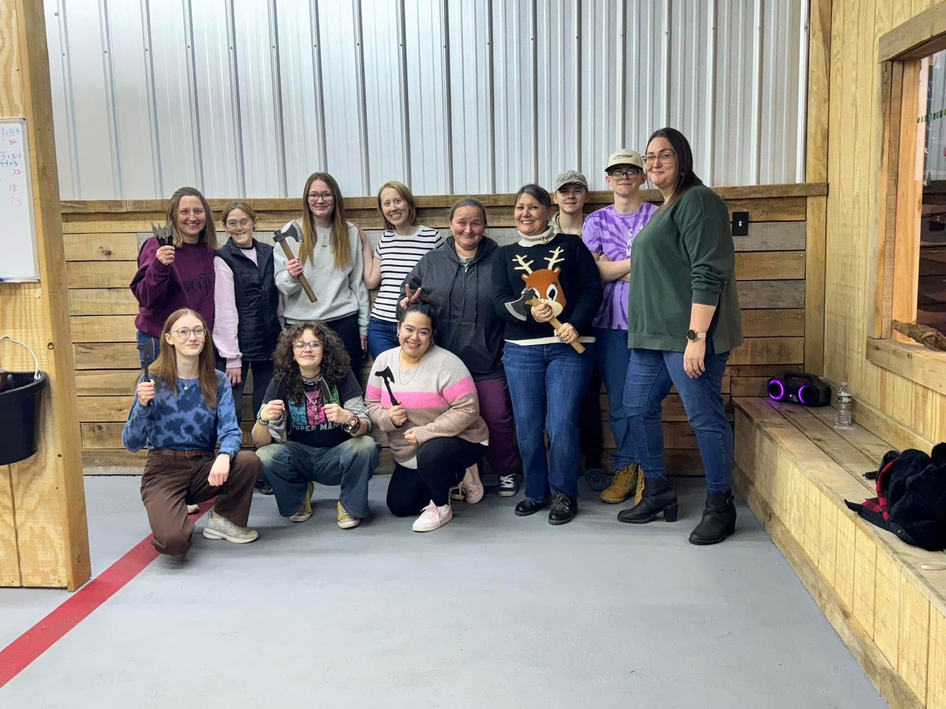 A group of women are posing for a picture in a room.