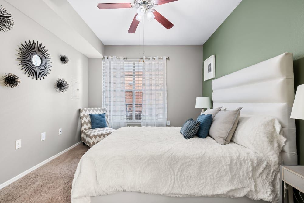 a bedroom with a large bed and a ceiling fan at Marquis on Gaston in Dallas, TX.