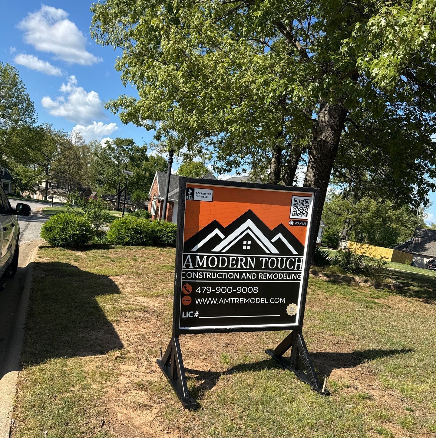 home with a modern touch sign in front yard