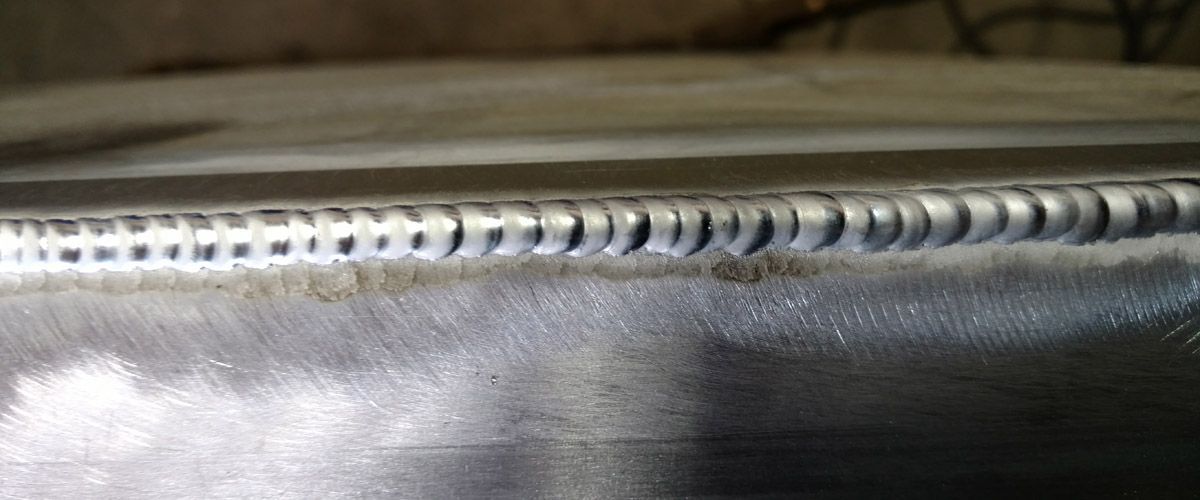 A close up of a welding joint on a metal surface.