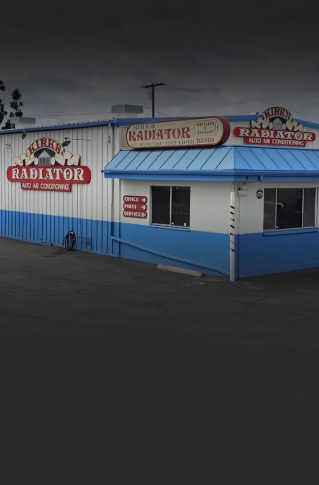 A white and blue building with the word radiator on it | Kirk's Radiator & Auto A/C Inc.