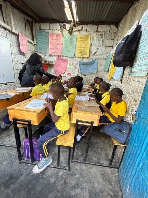 A group of children are sitting at desks in a classroom.