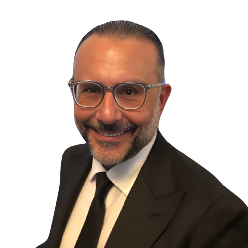 Smiling man in a dark suit and glasses, likely a professional portrait, against a white background.
