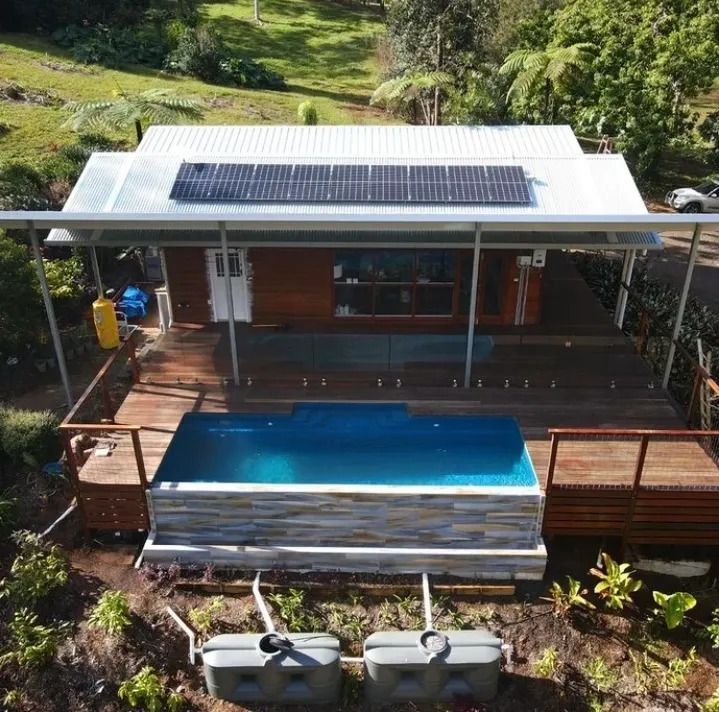 An View of a House With a Pool and Solar Panels on the Roof — Byron Bay Carpentry and Construction In Suffolk Park, NSW