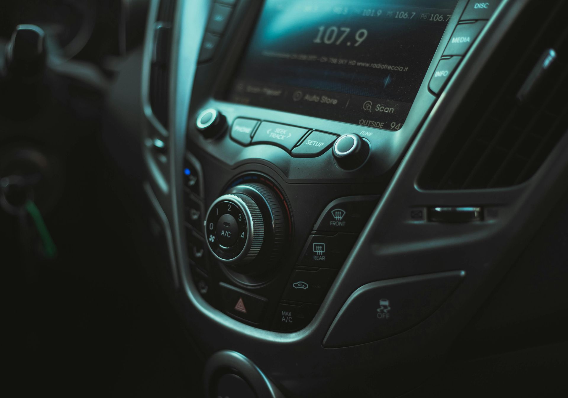 A close up of a car radio that says 107.9 on it