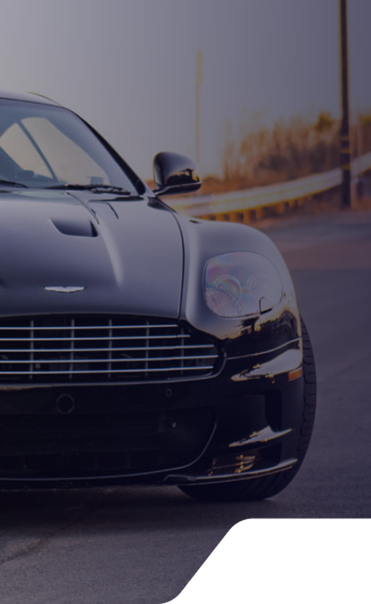 A white sports car is parked on the side of the road. | Response Motors