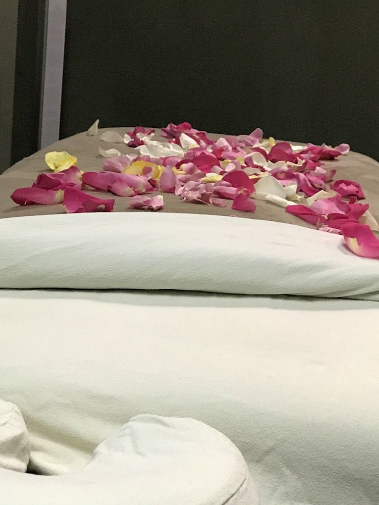 A Bed With Petals on It in a Spa