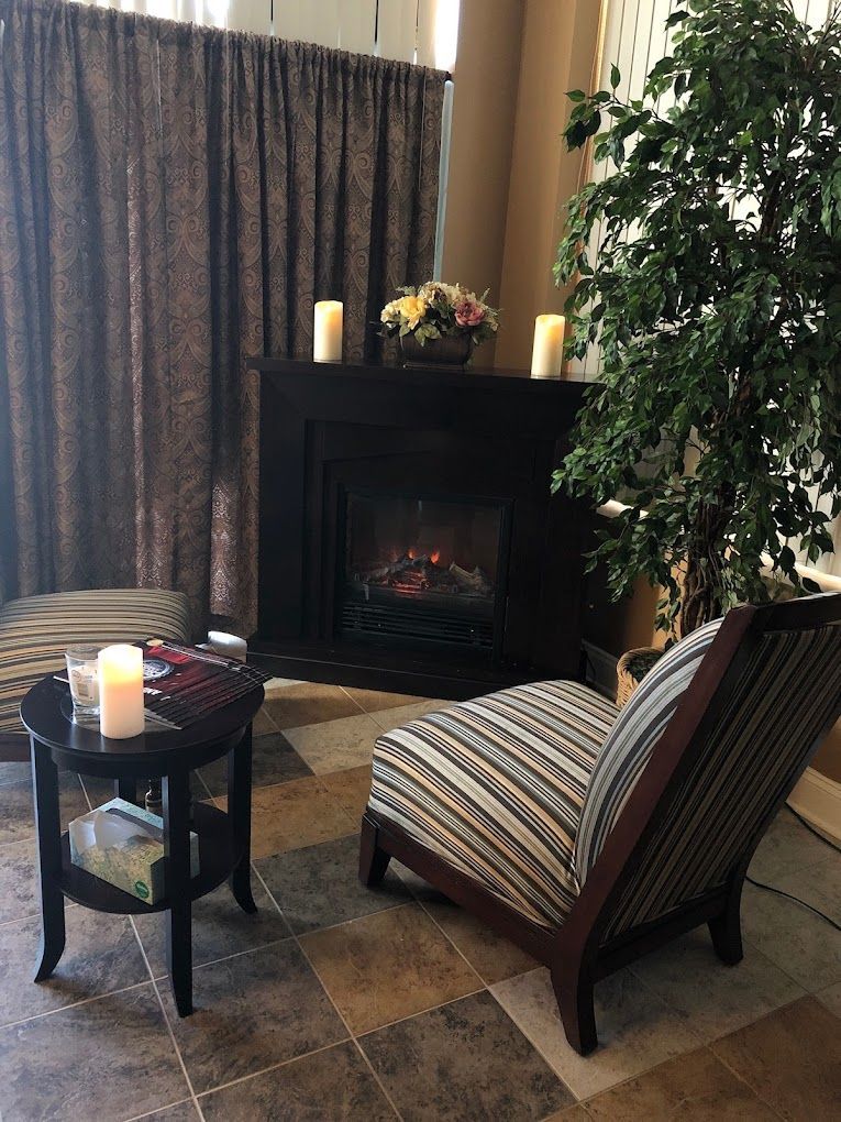 A Living Room With a Fireplace , Chair , Table and Candles
