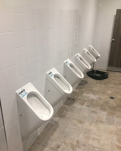 A plumber unblocking a sink in a home in Kurri Kurri