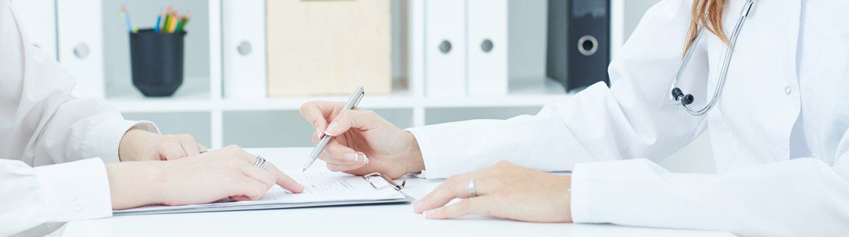 Doctor signing Patient forms at Melbourne Vascular