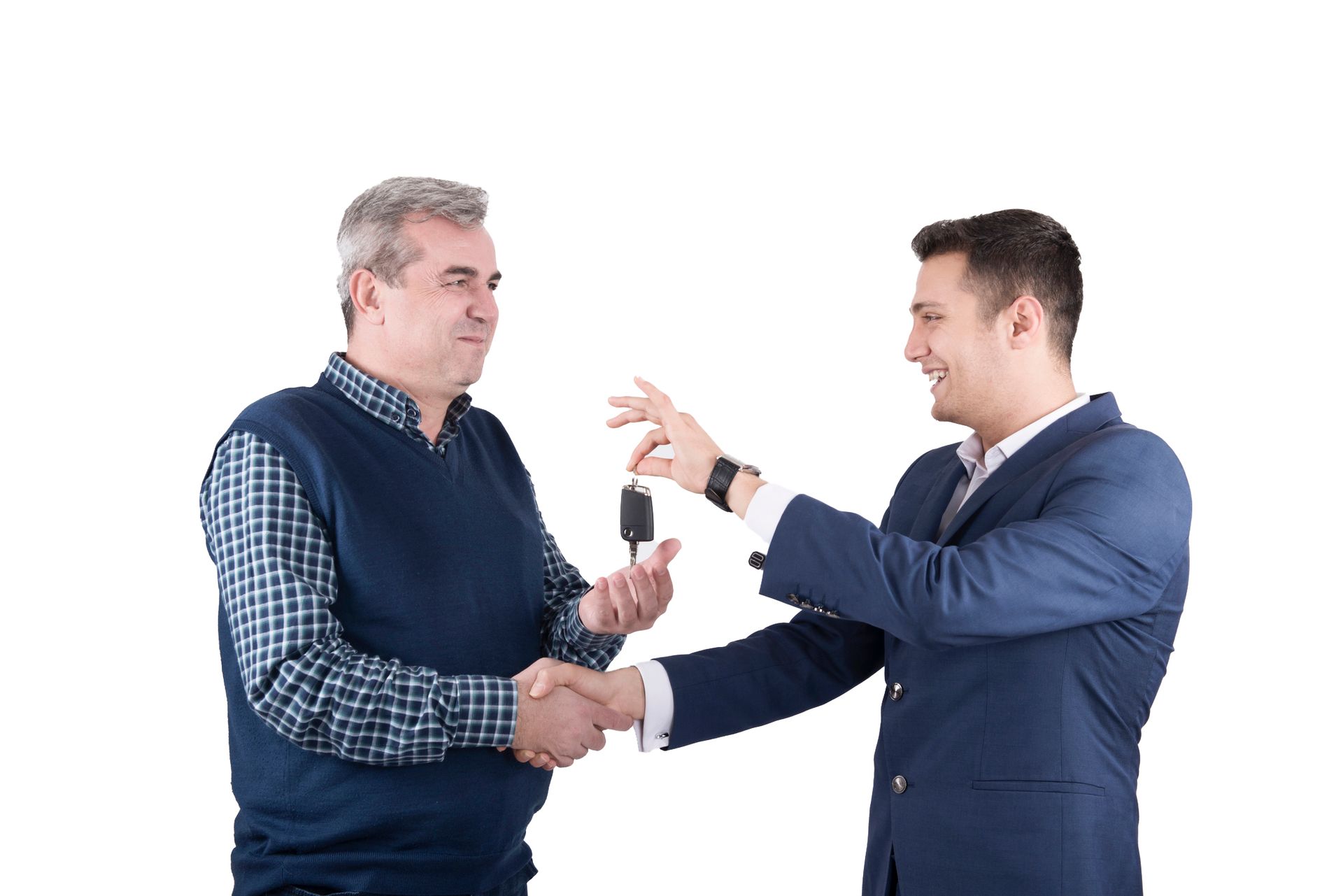 Man in suit hands car keys to another, shaking hands.
