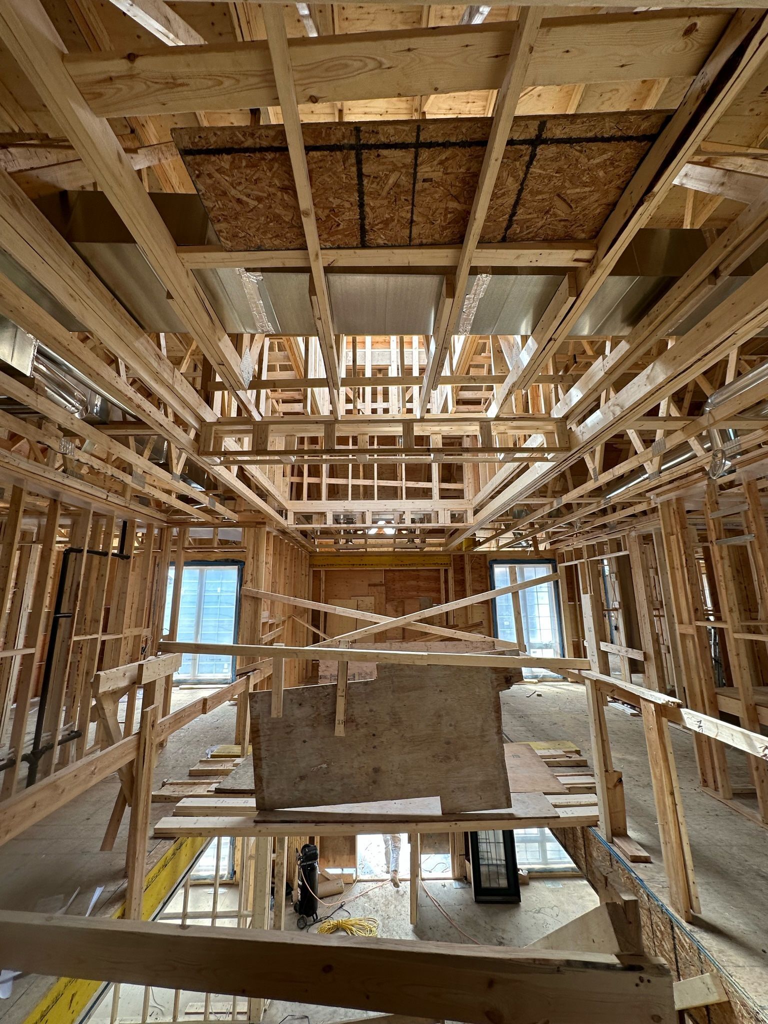 The inside of a building under construction with a lot of wooden beams.