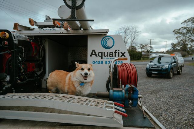 A Plumber Is Fixing A Sink With A Wrench — Aquafix Plumbing Services in Bowral, NSW
