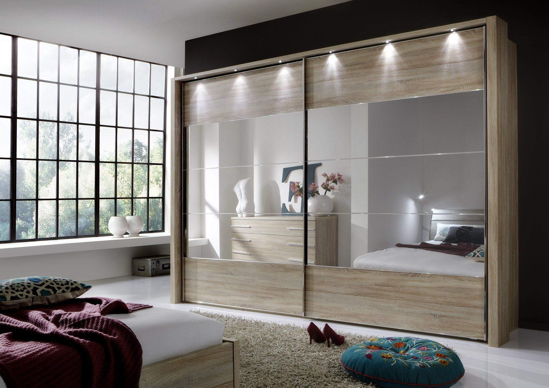 a beautiful bedroom furniture with wardrobes and tables