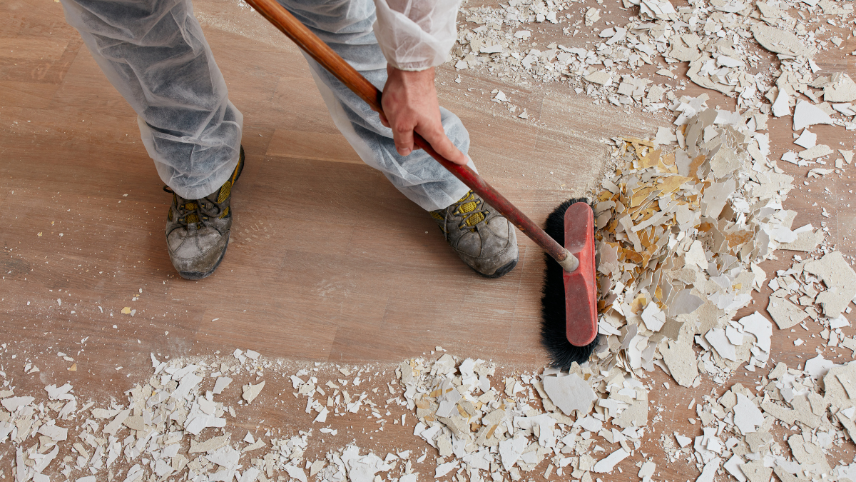 A person is sweeping the floor with a broom.