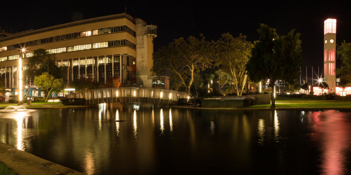 Large building by water at night - Total Clean Palmerston North Commercial Cleaning Services