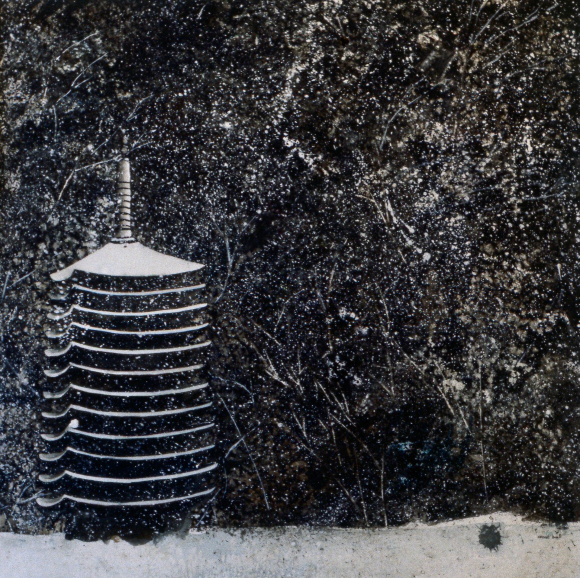 A black and white photo of a tower in the snow