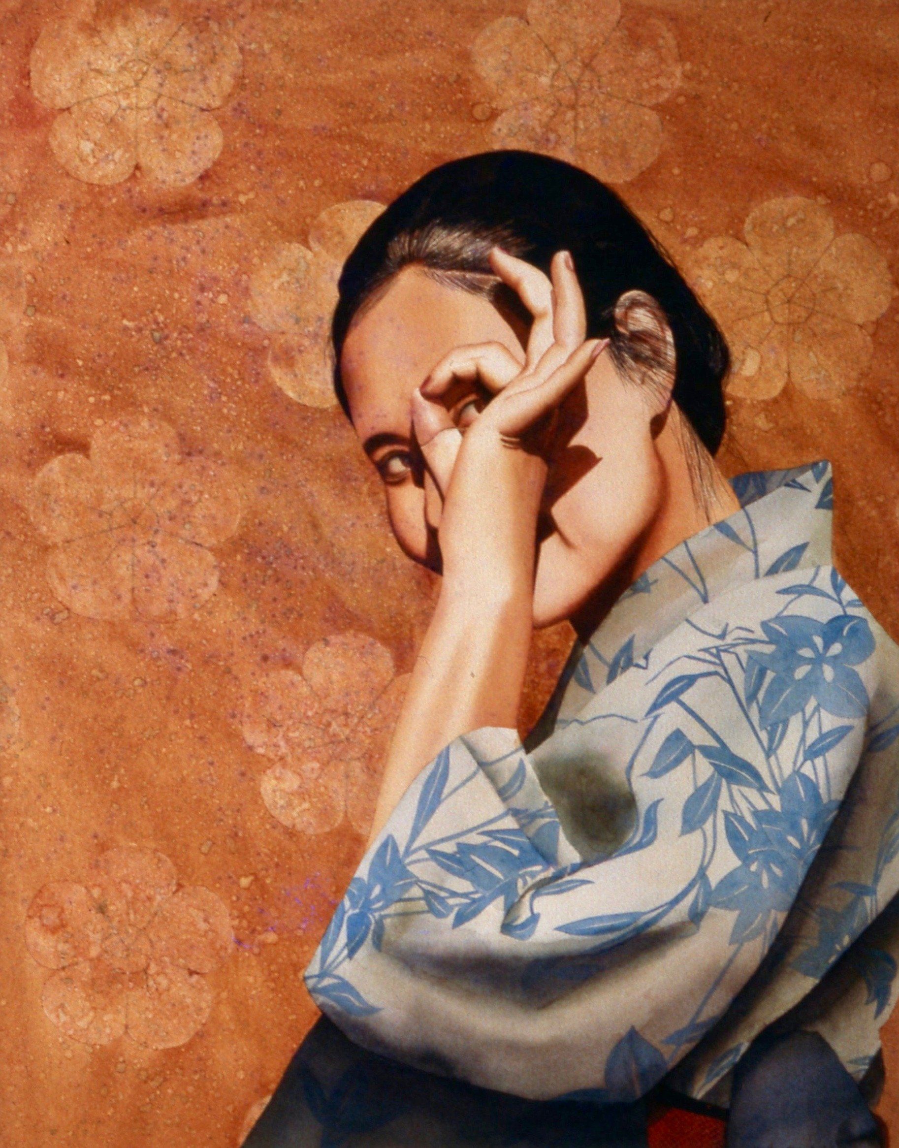 A woman in a kimono covering her face with her hands