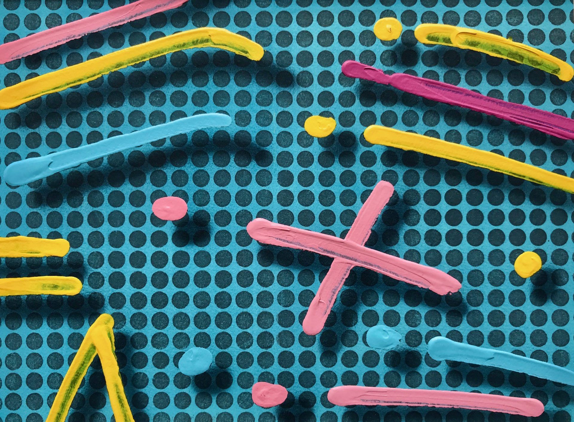 A bunch of colorful sticks are laying on a blue surface.