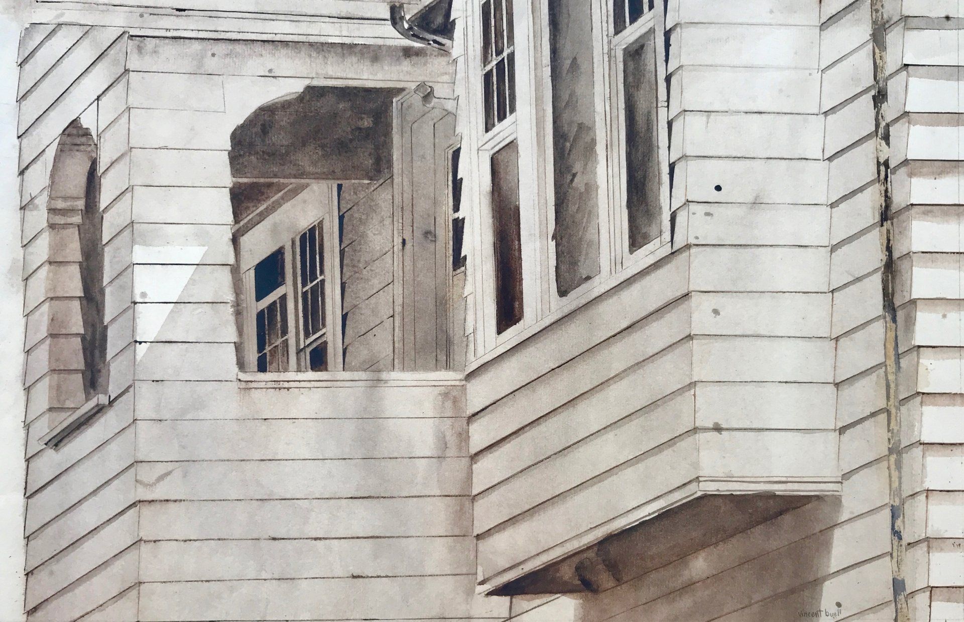 A black and white photo of a house with a balcony