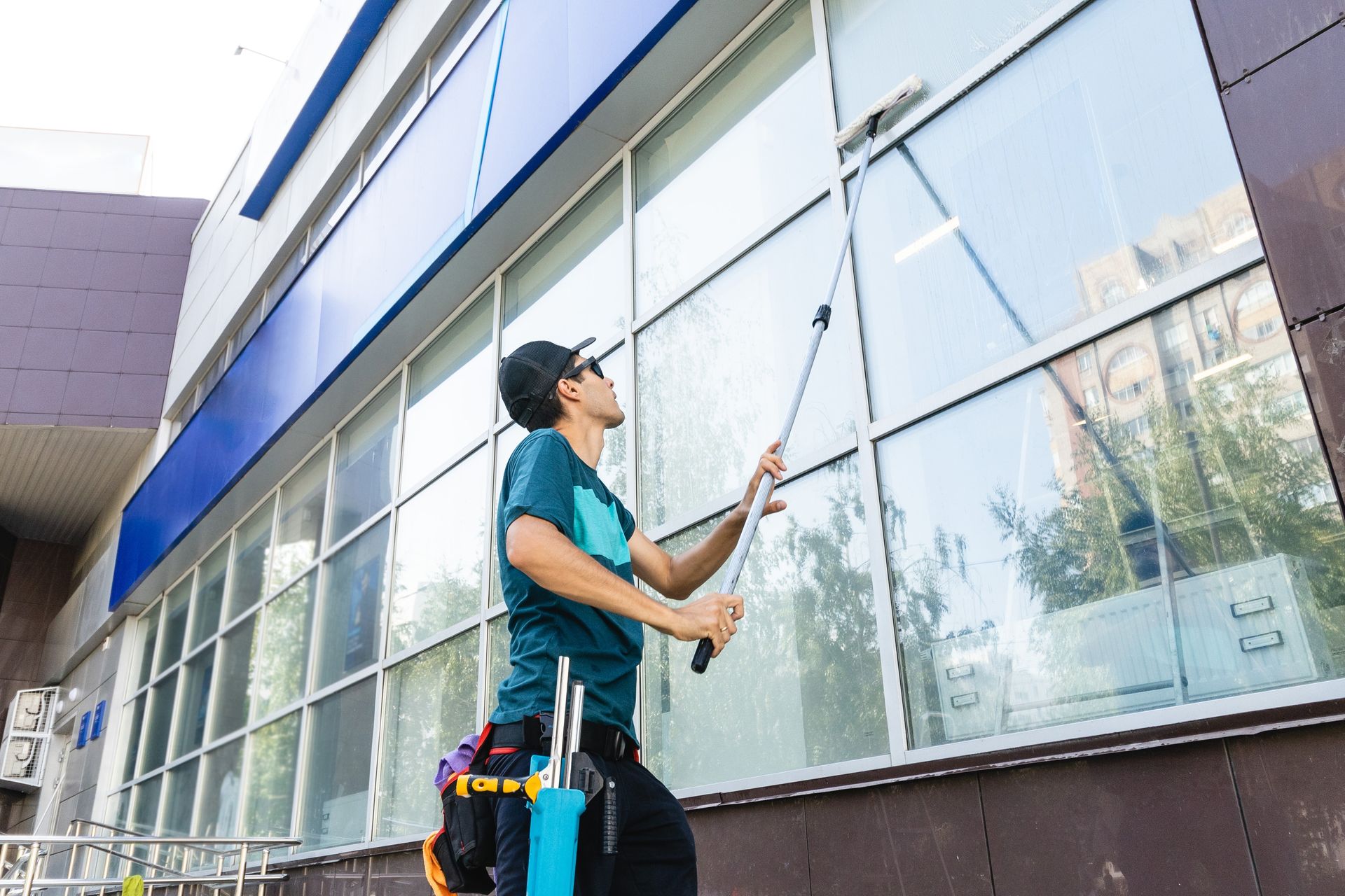 A man is cleaning the windows of a building.