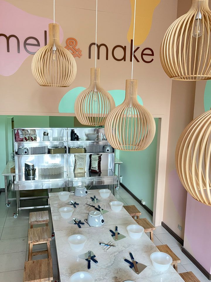 A long table with bowls and a sign that says make