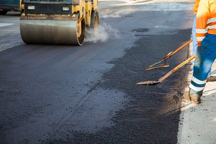 Workers Helping to Level the Asphalt — Ipswich, MA — Samco Paving