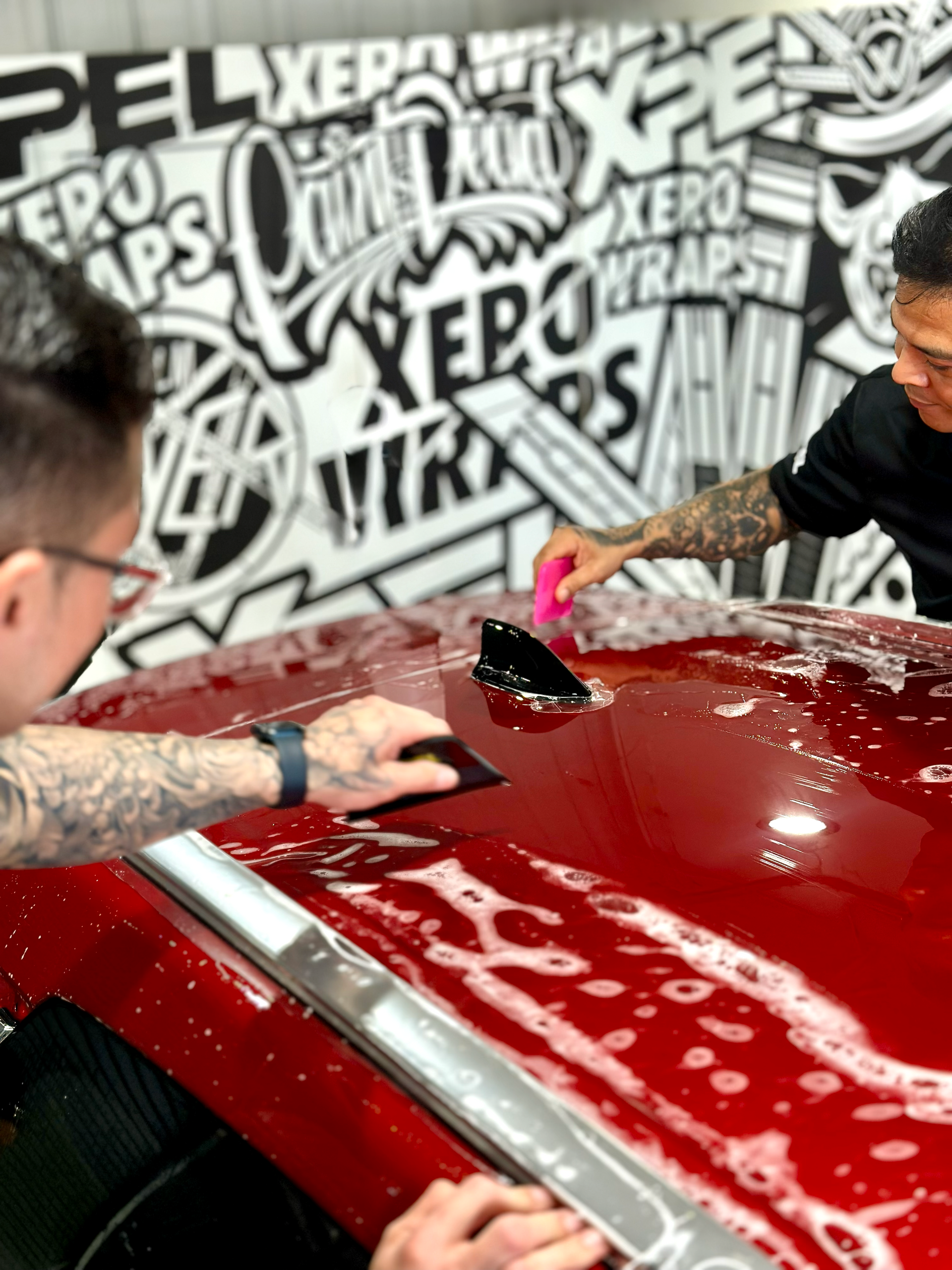 A blue sports car is parked on the side of the road.