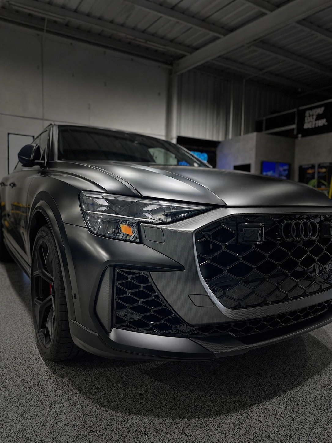 Gray Audi SUV in a garage, front three-quarter view with black grille and alloy wheels