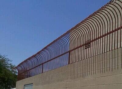 brown iron fence on top of wall - commercial iron fences & gates