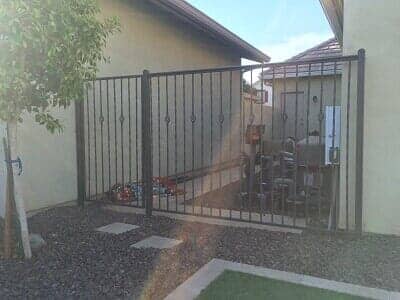 metal gate in between houses - residential iron fence contractor