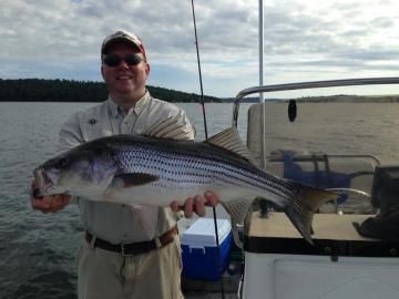 man holding striped bass