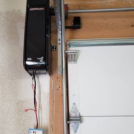 a garage door opener is attached to the side of a garage door.