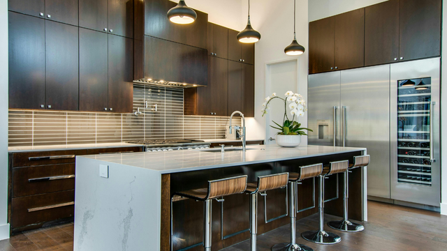 There is a large island in the middle of the kitchen.