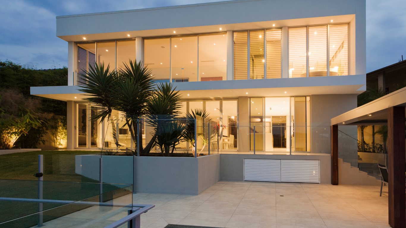 A large white house with a swimming pool in front of it