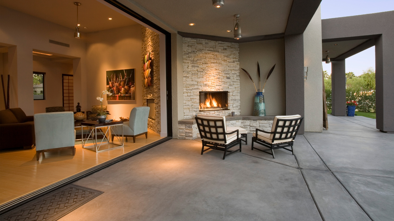 A patio with chairs and a fireplace in a house