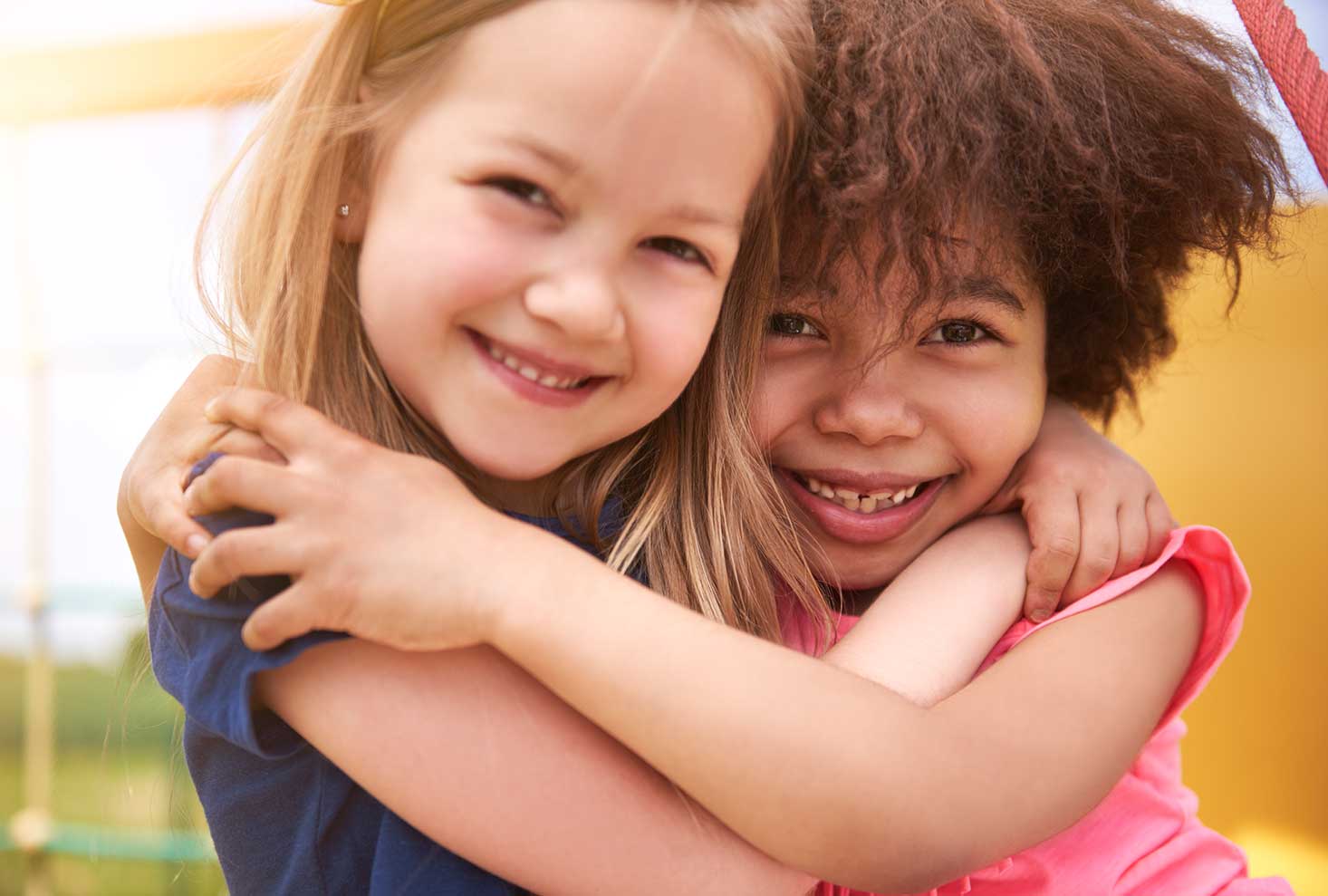 Two young friends hugging